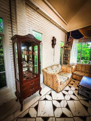 a living room with a couch and a cabinet at เรินนายหัว by KOYAD RESORT in Ban Wat Khao