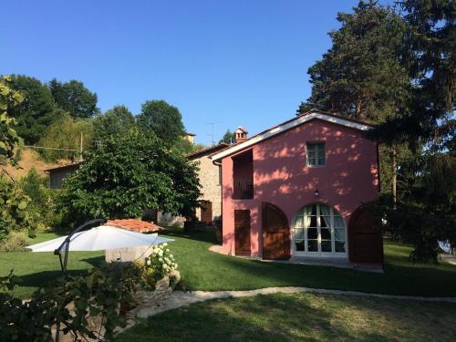 a red house in the yard of a house at Agriturismo Terrarossa in Pistoia