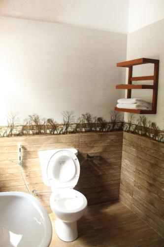 a bathroom with a toilet and a sink at Kandy Lotus Chalet in Kandy