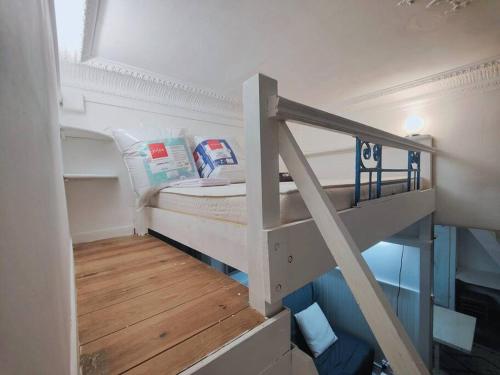 a small room with a bunk bed and a staircase at appartement parc des expositions/tour eiffel in Paris