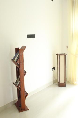 a room with a book shelf and a table at Kandy Lotus Chalet in Kandy