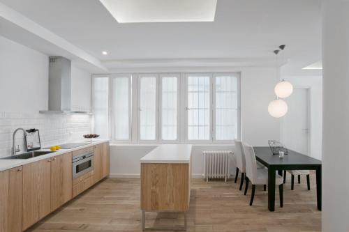 a kitchen with a table and a dining room at Angel Main Square Center Zagreb in Zagreb