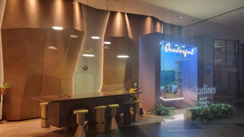 a store lobby with a mirror and a counter with stools at Sea View Sandy homestay Citadines Marina Ha Long in Ha Long