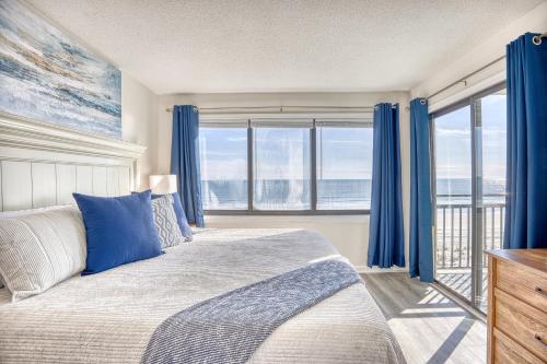 a bedroom with a bed and a window with blue curtains at Oceanfront 3br/2ba Dog Friendly in Myrtle Beach