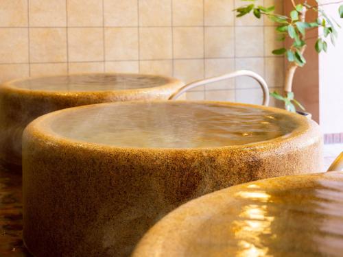 two large wooden bowls sitting on top of a counter at Hotel WBF Grande Asahikawa in Asahikawa