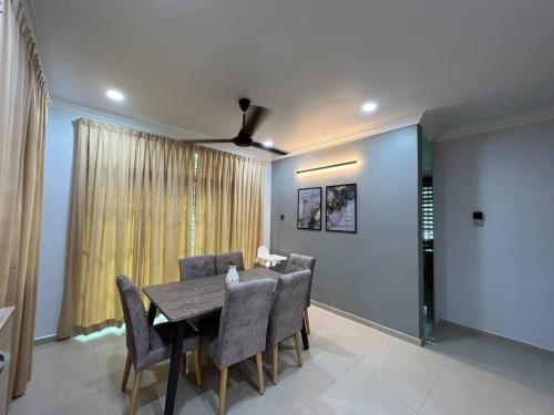 a dining room with a table and chairs at Bayu Homes(Cozy 4 BedRoom SemiD in KT City Center) in Kuala Terengganu