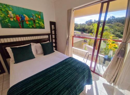 a bedroom with a bed and a large window at Ripple in time - 4 Adults & 2 kids Only in Umdloti