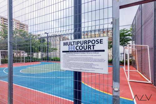 a sign on the fence of a tennis court at Urban Suites, Signature Collection by Stellar ALV in Jelutong
