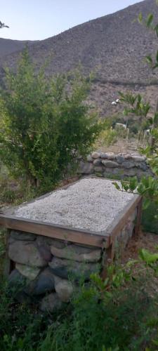 a stone bench sitting on top of a pile of gravel at DIAGUITAS, VICUÑA, VALLE DEL ELQUI in Diaguita