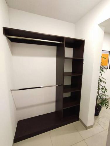 a closet with a black and white wall at Departamento para ejecutivo con vista panorámica in Querétaro