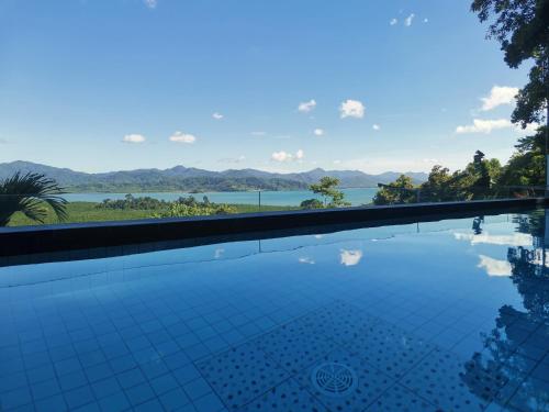 a swimming pool with a view of the water at RC Villas and Resorts in El Nido