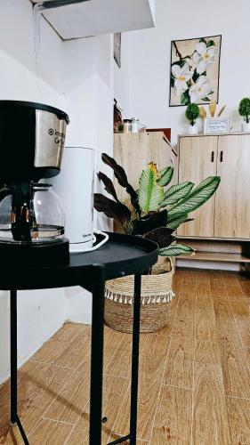 a kitchen with a table with a coffee maker on it at City Nest in Iloilo City