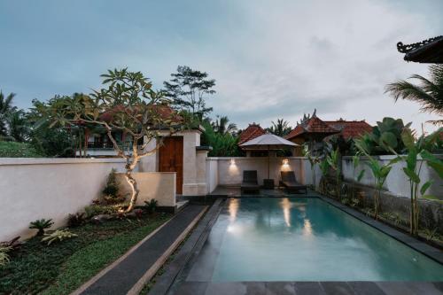 a swimming pool in the backyard of a house at Meng Bengil Villa in Ubud
