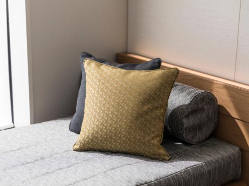 a pillow sitting on a couch in a room at Tokyu Stay Hida Takayama Musubinoyu in Takayama
