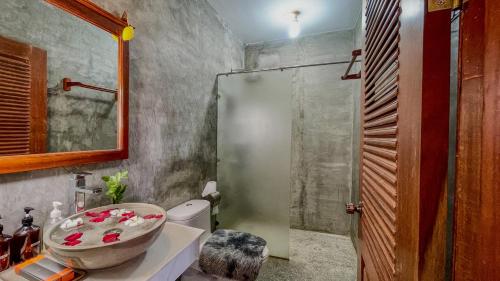 a bathroom with a sink and a toilet and a shower at Villa Indochine d'Angkor in Siem Reap