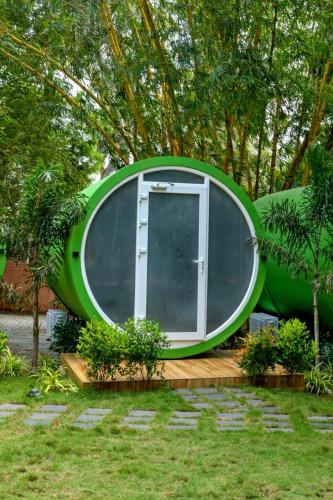 a circular house with a door in a garden at GoGo Land Resort & Adventurous Sports in Pūvār