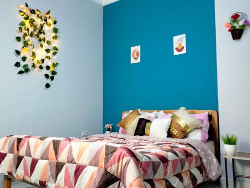 a bedroom with a bed with a blue wall at Joy Homes in Cairo