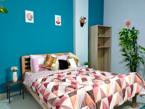 a bedroom with a bed with a blue wall at Joy Homes in Cairo