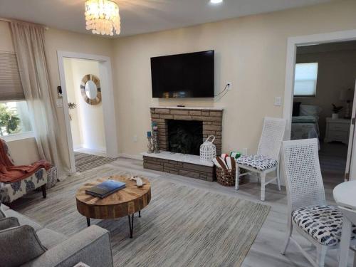 a living room with a fireplace and a tv at Completely Renovated! Half Duplex 1mile to Beach in Nokomis