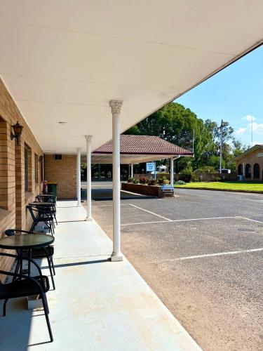 a group of tables and chairs in a parking lot at Gilgandra Motel in Gilgandra