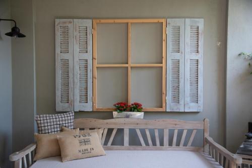 a room with a table and some shuttered windows at Roptro in Doliana