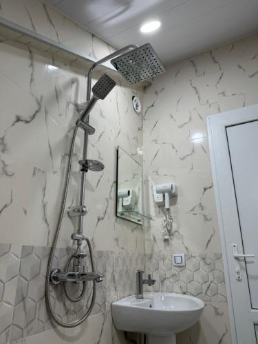 a bathroom with a shower and a sink at Nikita's Old Tbilisi in Tbilisi City