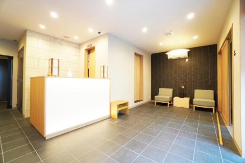 a waiting room with two chairs and a whiteboard at Matatabi Stay Nishinokyo in Kyoto