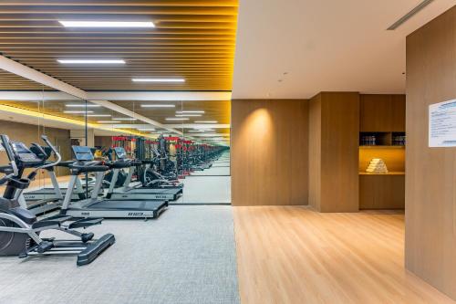 a gym with a row of treadmills and ellipticals at Holiday Inn Express Suzhou Bay by IHG in Suzhou