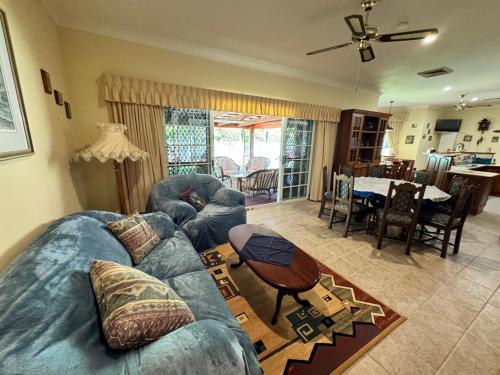 a living room with a blue couch and a table at Oasis of Hope - Main House in Upper Orara