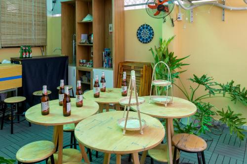 a room with wooden tables with bottles on them at Saigon Authentic Hostel - Cozy Rooftop, Family Cooking Experience, FREE Walking Tour, Vietnamese Breakfast & Gym in Ho Chi Minh City