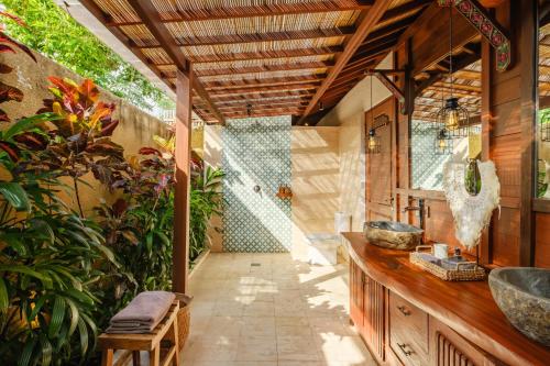 an outdoor bathroom with a shower and a sink at Villa Asrava Ubud in Ubud