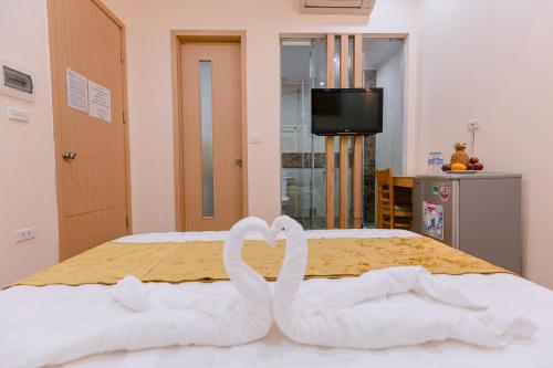 two white swans making a heart on a bed at Golden Diamond Hotel in Hanoi