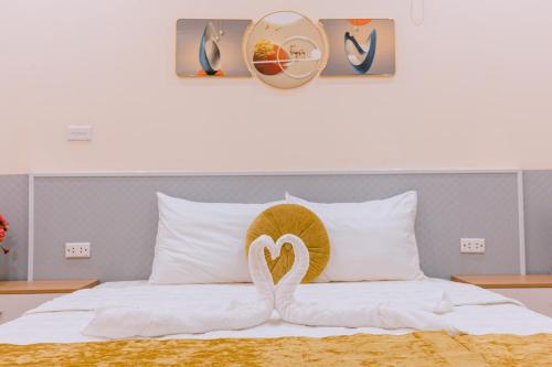 a bed with a stuffed animal on top of it at Golden Diamond Hotel in Hanoi