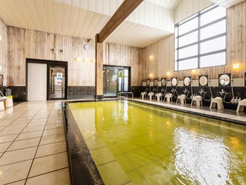 a pool of water in a room with chairs at Nagoya Crown Hotel in Nagoya