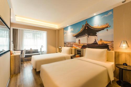 a hotel room with two beds and a painting on the wall at Atour Hotel Beijing Zhongguancun Life Science Park in Yongfengtun