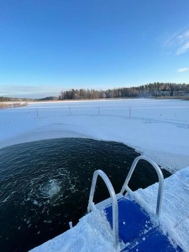 a boat in a body of water with snow at Poukama in Porvoo