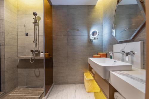 y baño con lavabo y ducha. en Atour Hotel Kunming International Trade Center, en Kunming