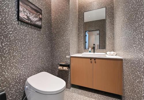 a bathroom with a toilet and a sink and a mirror at Atour Hotel Beijing Hepingli UIBE in Beijing