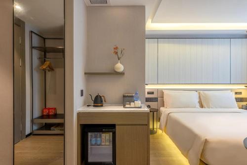 a hotel room with a bed and a table with a fireplace at Atour S Hotel Shenzhen Futian Port in Shenzhen