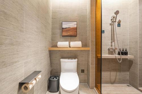 a bathroom with a toilet and a shower at Atour Hotel Shanghai New International Expo Center South Yanggao Road in Shanghai