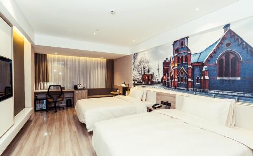 a hotel room with two beds and a painting of a church at Atour Hotel Shanghai Pudong Airport in Shanghai