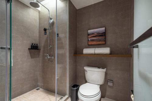 a bathroom with a toilet and a glass shower at Atour Hotel Shanghai Hongqiao Xinzhuang Business District in Shanghai