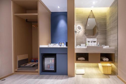 a bathroom with a fireplace and a sink at Atour Hotel Chengdu Wenshufang in Chengdu
