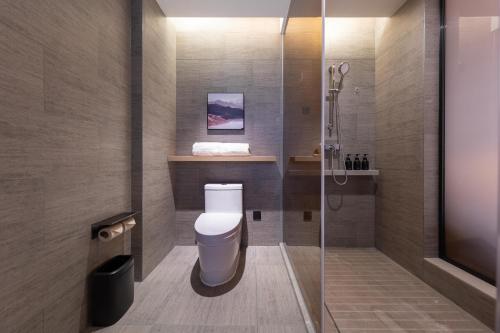 a bathroom with a toilet and a shower at Atour Hotel Guangzhou Liwan District Jiaokou in Guangzhou