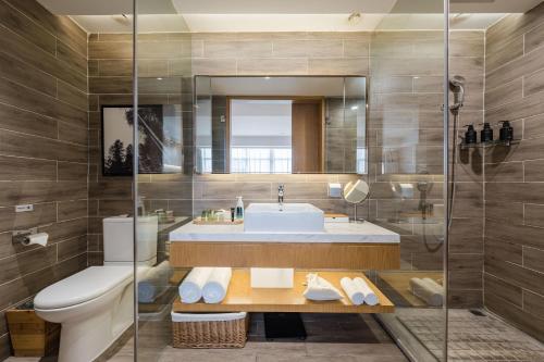 a bathroom with a sink and a toilet at Atour X Hotel Wuxi New Zone Gelunbu Plaza in Wuxi