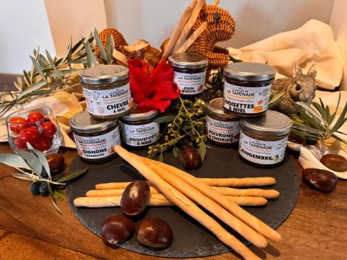 a table with carrots and jars of jam and vegetables at Le Clos FMR Insolite - "F"anny Carcassonne in Malves-en-Minervois