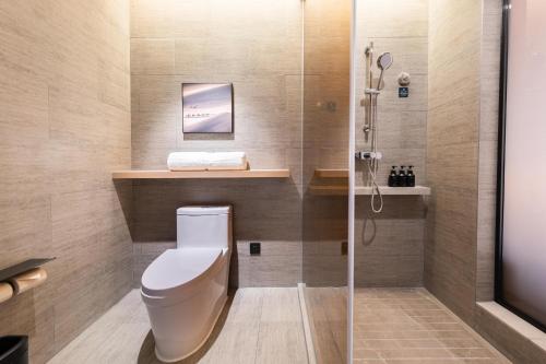 a bathroom with a toilet and a shower at Atour Hotel Guangzhou Liwan District Jiaokou in Guangzhou