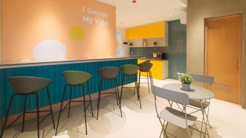 a kitchen with a blue counter and stools at Sans Hotel at One JD Place Makati by RedDoorz in Manila