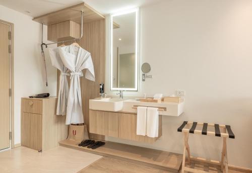 a bathroom with a sink and a mirror at U Hua Hin in Cha Am
