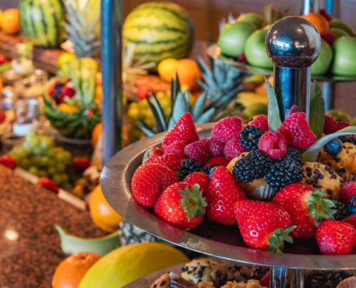 a plate of strawberries and other fruit on a buffet at PLAZA Premium Timmendorfer Strand in Timmendorfer Strand